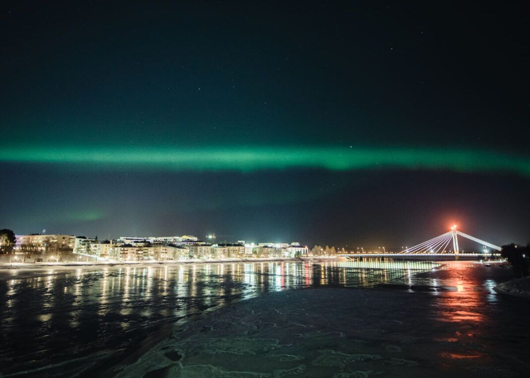 Lumberjack's Candle Bridge with Northern Lights in Rovaniemi Lapland Finland